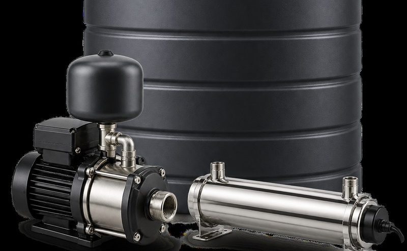 A stainless multistage booster pump and pressure vessel beside a large storage tank.